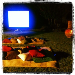 Picture of a movie screen set up in the backyard